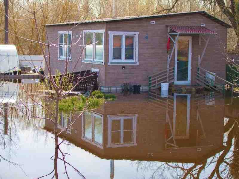 Floodwater surrounding a home showing why elevation certificate records matter for flood prone property review